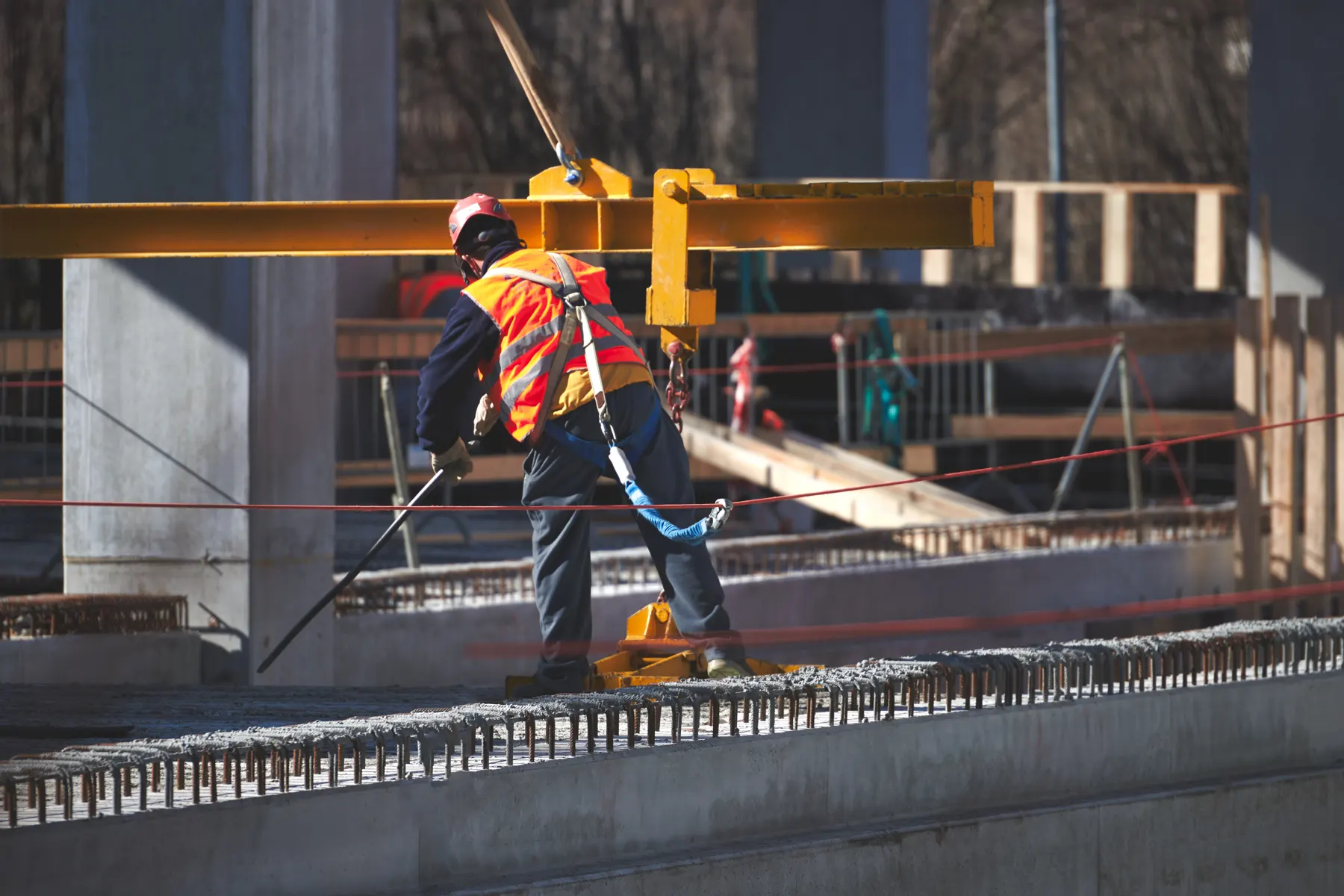 Worker in safety gear on an industrial steel structure